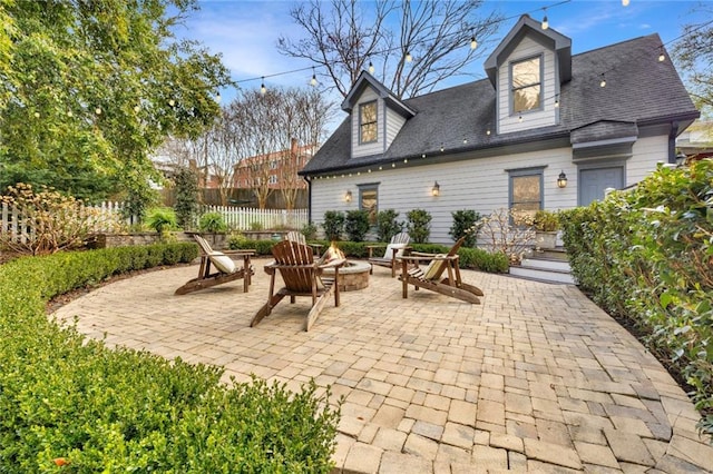 view of patio / terrace featuring an outdoor fire pit and fence