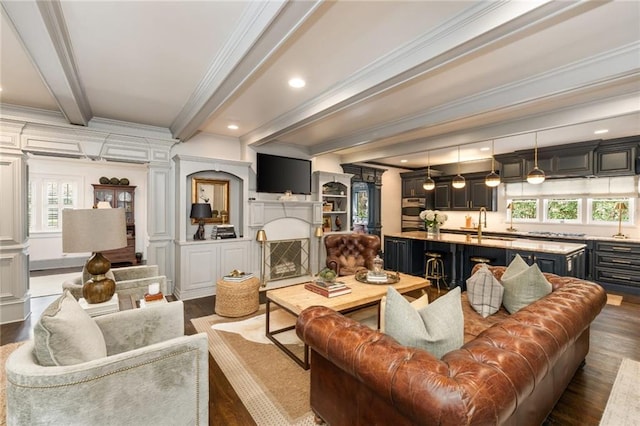 living room with recessed lighting, a fireplace, beam ceiling, dark wood finished floors, and crown molding