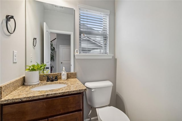 bathroom featuring vanity and toilet