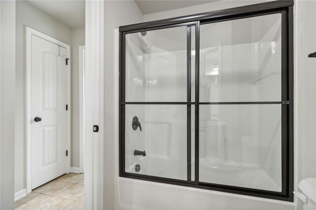 bathroom with shower / bath combination with glass door and tile patterned floors