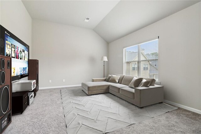 living room with vaulted ceiling and light colored carpet