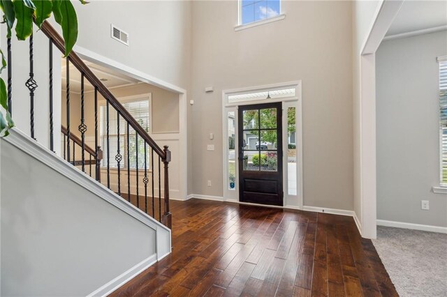 entrance foyer featuring dark hardwood / wood-style flooring and a high ceiling