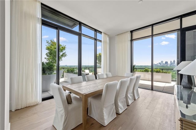 2425 Peachtree Rd NE Unit 1503, Atlanta, GA 30305 - dining space with expansive windows, a skyline view, and light wood-style flooring