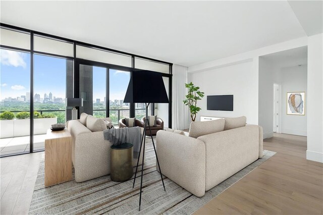 2425 Peachtree Rd NE Unit 1503, Atlanta, GA 30305 - living room with floor to ceiling windows, a view of skyline, wood finished floors, and baseboards