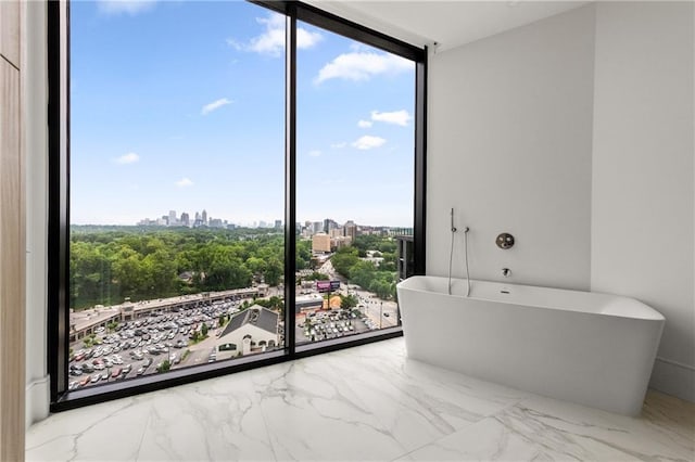 2425 Peachtree Rd NE Unit 1503, Atlanta, GA 30305 - bathroom with a wall of windows, a soaking tub, a city view, and marble finish floors