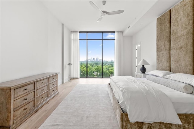 2425 Peachtree Rd NE Unit 1503, Atlanta, GA 30305 - bedroom with a wall of windows, light wood-style floors, and a ceiling fan