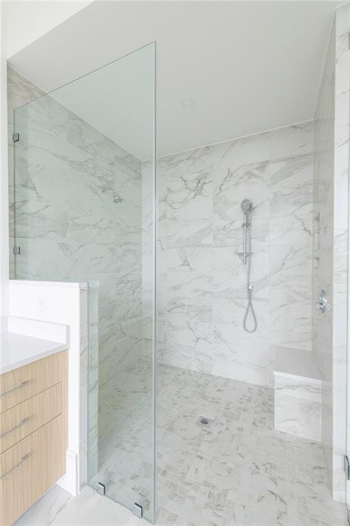 2425 Peachtree Rd NE Unit 1503, Atlanta, GA 30305 - bathroom featuring a marble finish shower, vanity, and marble look tile flooring