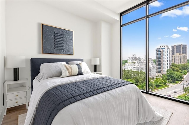 2425 Peachtree Rd NE Unit 1503, Atlanta, GA 30305 - bedroom featuring wood finished floors, expansive windows, and a view of city