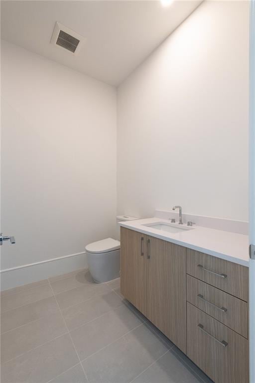 2425 Peachtree Rd NE Unit 1503, Atlanta, GA 30305 - bathroom featuring vanity, toilet, tile patterned floors, and baseboards