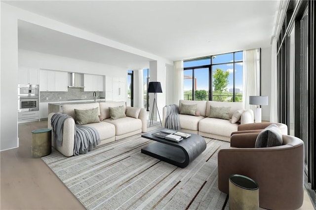 2425 Peachtree Rd NE Unit 1503, Atlanta, GA 30305 - living room featuring light wood-style flooring and a wall of windows