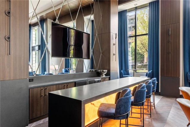 2425 Peachtree Rd NE Unit 1503, Atlanta, GA 30305 - kitchen with a breakfast bar, modern cabinets, a center island, and dark countertops