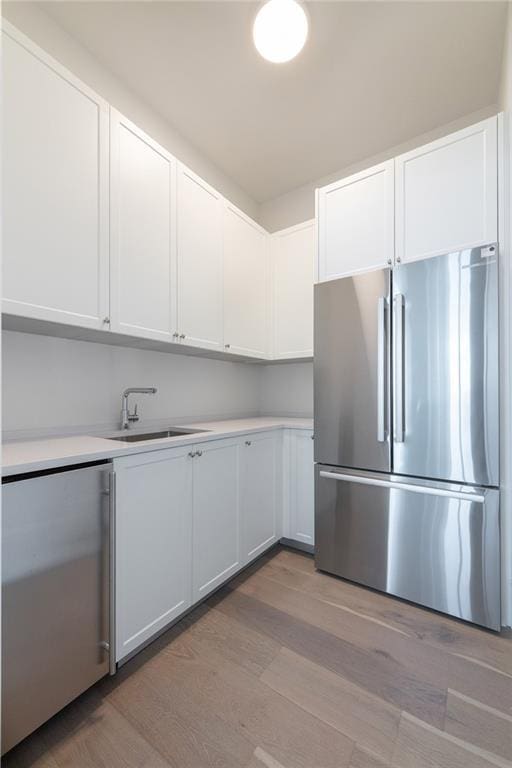 2425 Peachtree Rd NE Unit 1503, Atlanta, GA 30305 - kitchen with freestanding refrigerator, a sink, fridge, and light wood-type flooring