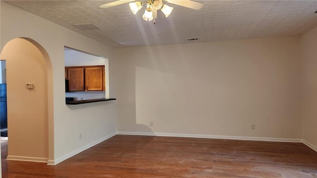 unfurnished room featuring hardwood / wood-style floors, a textured ceiling, and ceiling fan