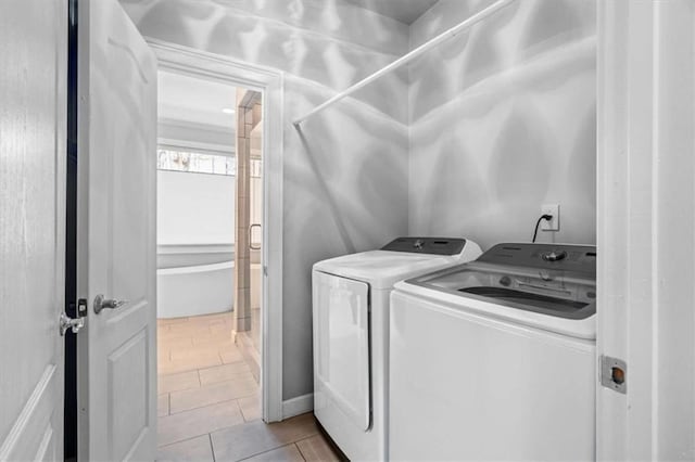 clothes washing area featuring laundry area, tile patterned flooring, and independent washer and dryer