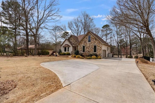 view of front of home with stone siding and driveway