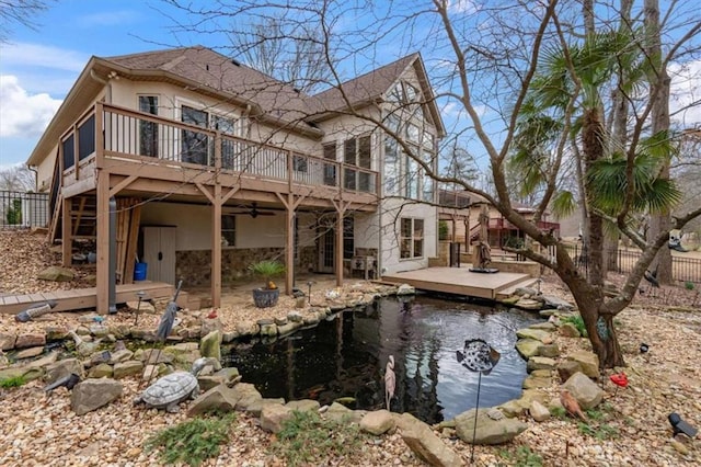 back of house with a patio, a wooden deck, and fence