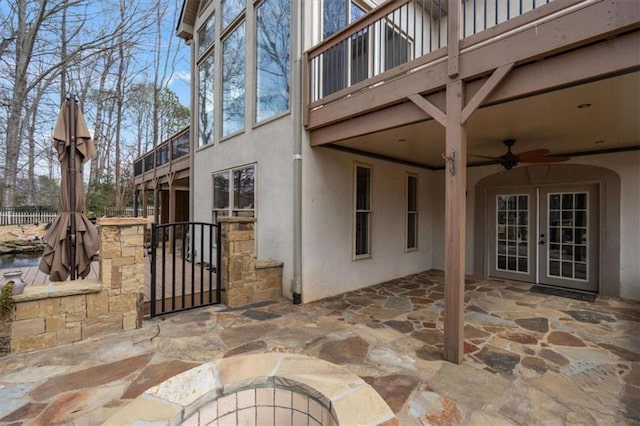 view of patio featuring a gate, french doors, fence, and ceiling fan