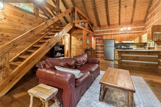 251 Honeysuckle Way, Blue Ridge, GA 30513 - living room with wooden ceiling with exposed beams, wooden walls, light wood-type flooring, a chandelier, and high vaulted ceiling