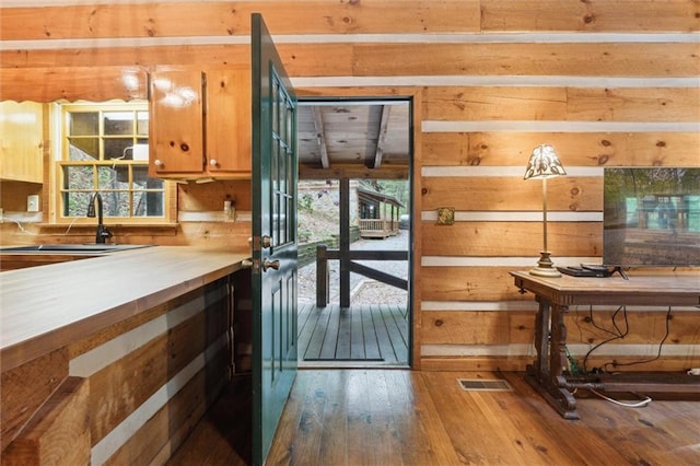 251 Honeysuckle Way, Blue Ridge, GA 30513 - kitchen with wooden walls, hardwood / wood-style flooring, a sink, and brown cabinetry