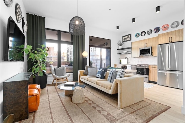 567 Ponce De Leon Ave NE Unit 606, Atlanta, GA 30308 - living room with plenty of natural light and light wood-style floors