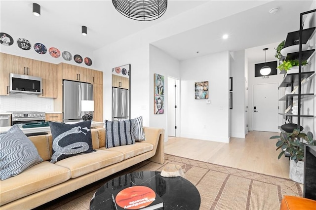 567 Ponce De Leon Ave NE Unit 606, Atlanta, GA 30308 - living room featuring light wood finished floors and baseboards