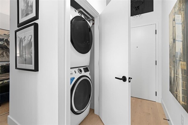 567 Ponce De Leon Ave NE Unit 606, Atlanta, GA 30308 - laundry room featuring stacked washer / dryer and light wood-style floors