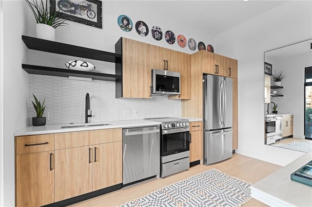 567 Ponce De Leon Ave NE Unit 606, Atlanta, GA 30308 - kitchen featuring stainless steel appliances, open shelves, a sink, and light wood-style flooring
