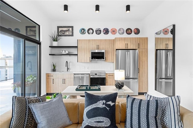 567 Ponce De Leon Ave NE Unit 606, Atlanta, GA 30308 - kitchen with stainless steel appliances, a sink, open shelves, decorative backsplash, and light countertops