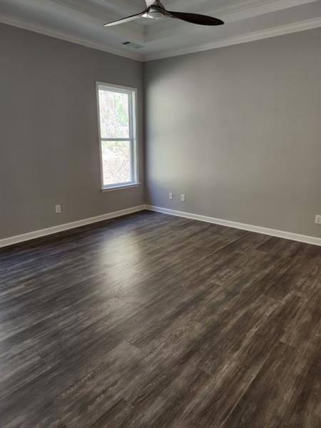 empty room featuring ornamental molding and dark wood finished floors