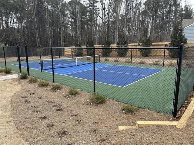 view of sport court featuring fence