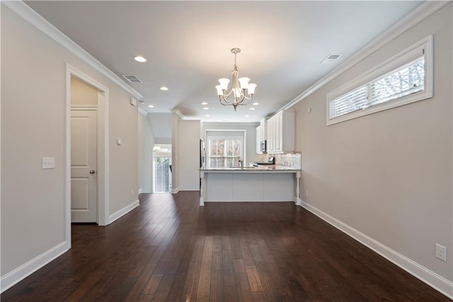 kitchen featuring white cabinets, dark hardwood / wood-style floors, and ornamental molding