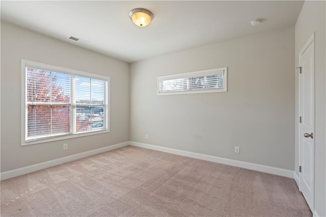 carpeted spare room with plenty of natural light