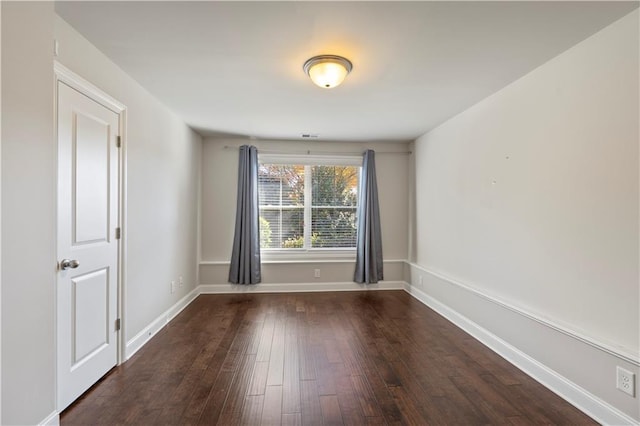 empty room featuring dark wood-type flooring