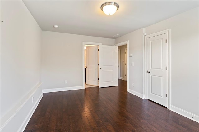 unfurnished bedroom with dark wood-type flooring