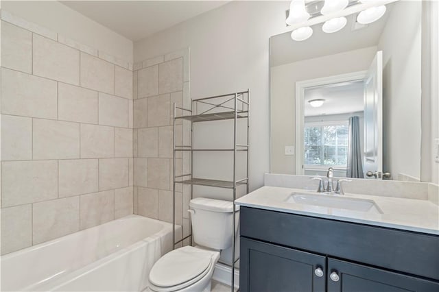 full bathroom featuring vanity, tiled shower / bath combo, and toilet