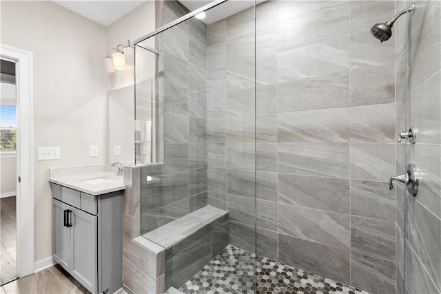 bathroom featuring vanity and tiled shower