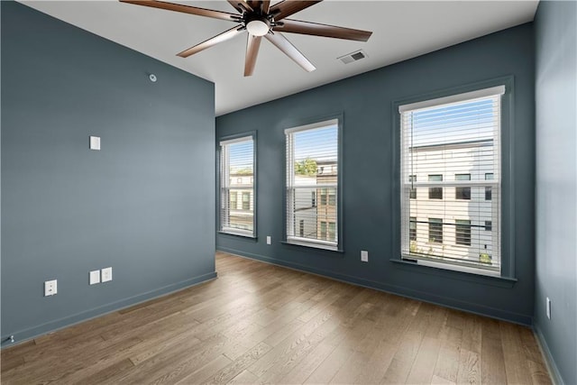 empty room with ceiling fan and hardwood / wood-style floors