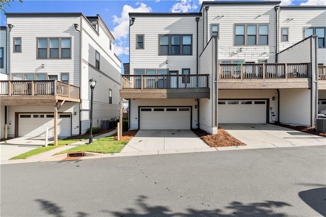 view of front of house with central AC unit and a garage