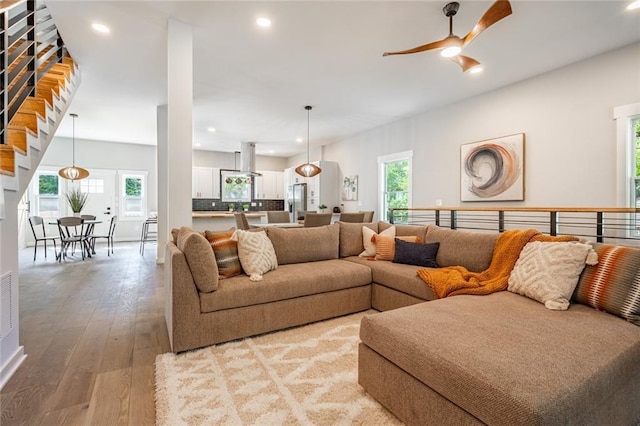 living room with ceiling fan and wood-type flooring