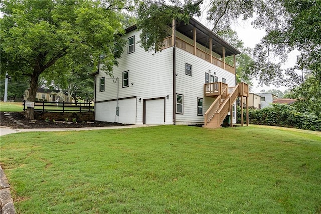 view of home's exterior with a balcony, a garage, and a yard