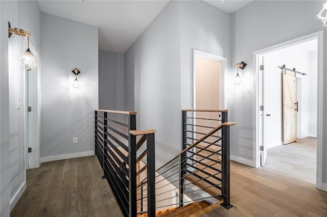 hallway featuring hardwood / wood-style flooring and a barn door