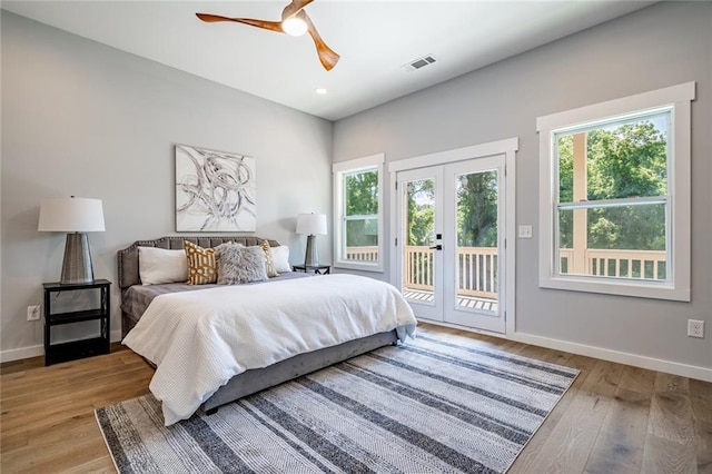 bedroom featuring light hardwood / wood-style floors, ceiling fan, french doors, and access to outside