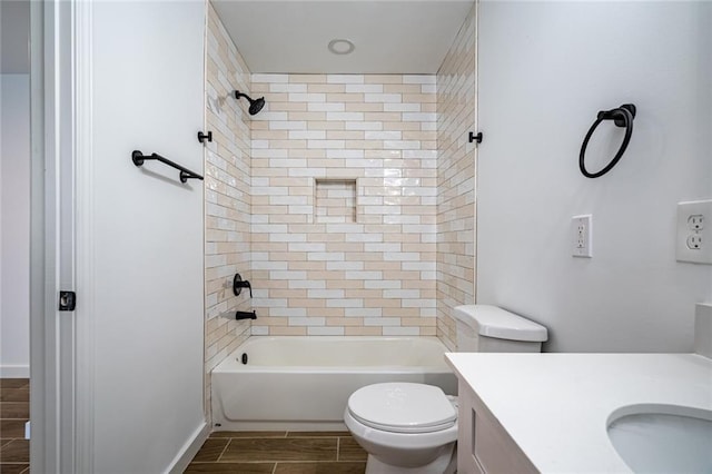 full bathroom with vanity, toilet, and tiled shower / bath combo