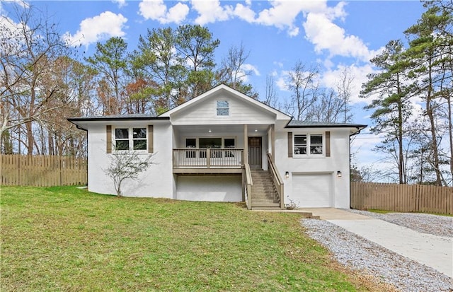 view of front of property with a garage, covered porch, and a front lawn