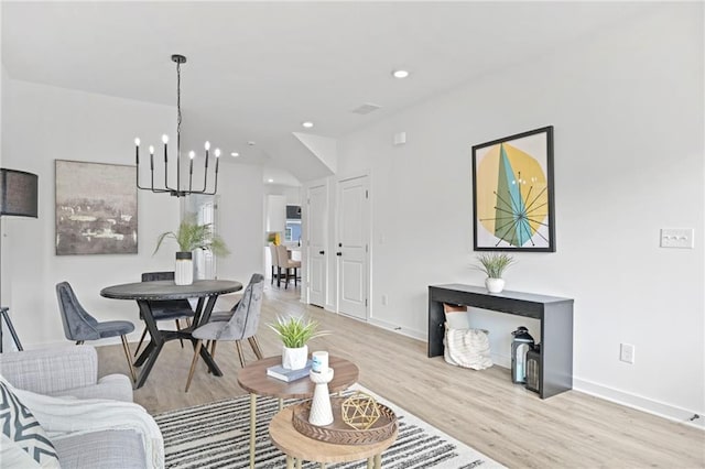 living area featuring a notable chandelier, recessed lighting, baseboards, and light wood-style floors