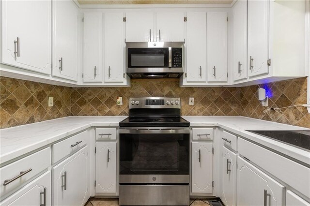 kitchen featuring appliances with stainless steel finishes, tasteful backsplash, and white cabinetry