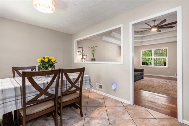 dining room with light tile patterned floors, baseboards, ceiling fan, and visible vents