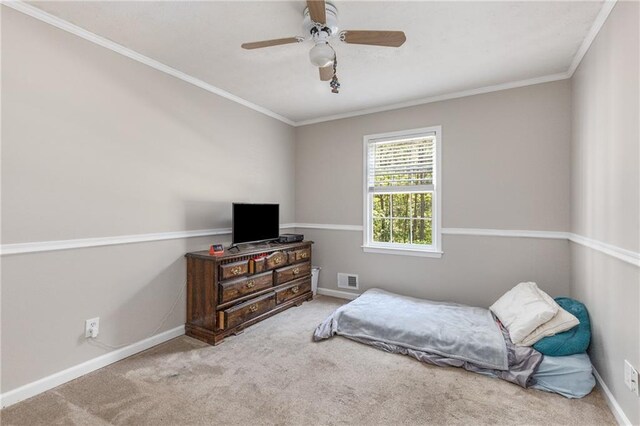 carpeted bedroom featuring crown molding, baseboards, ceiling fan, and visible vents
