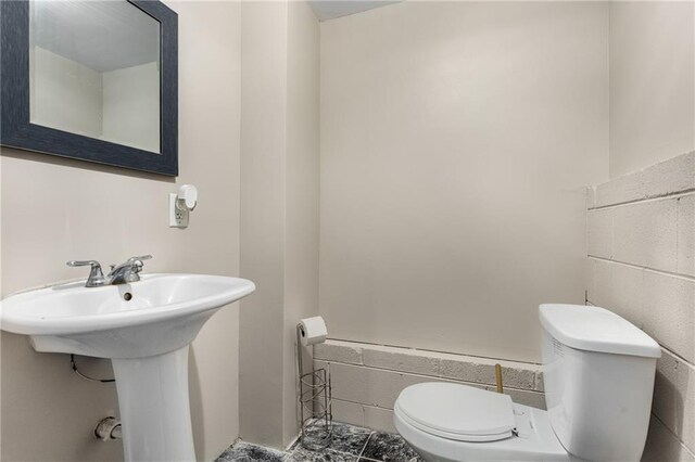 bathroom featuring toilet and a sink