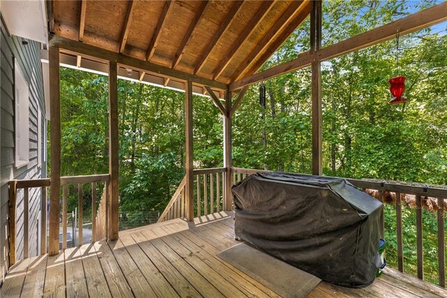 wooden deck featuring a grill